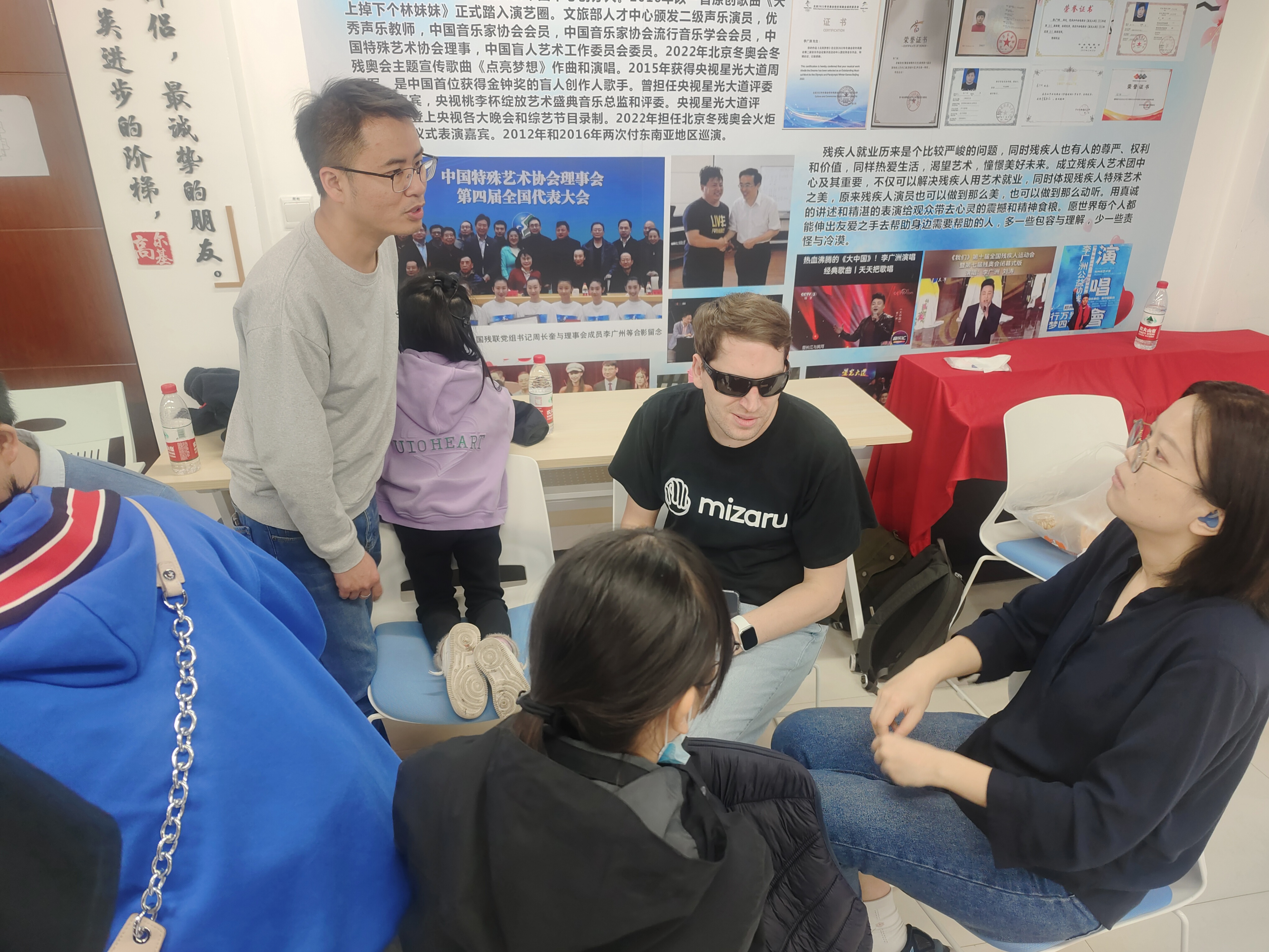 Participants engaged in collaborative discussion and communication during a community-focused accessibility session.
